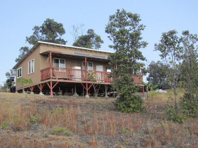 92-8629 Koa Lane Ocean View, HI 96704 - Photo 1 of 12 a front view of a house with a yard