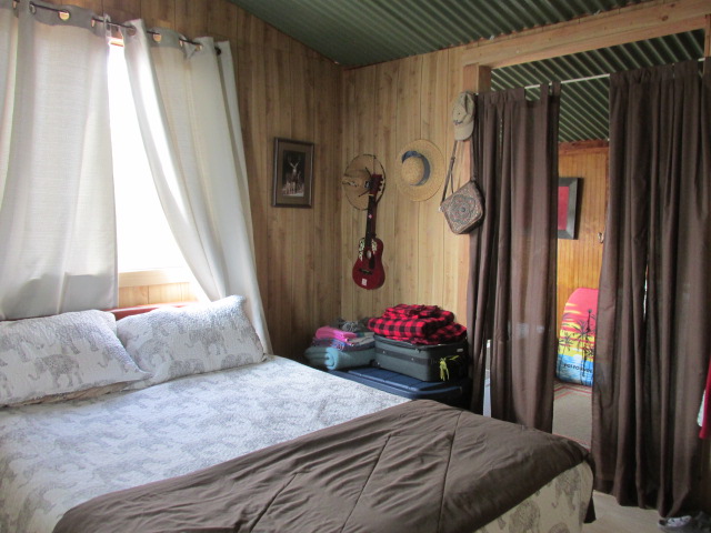 92-8629 Koa Lane Ocean View, HI 96704 - Photo 2 of 12 a bedroom with a bed dresser and a window