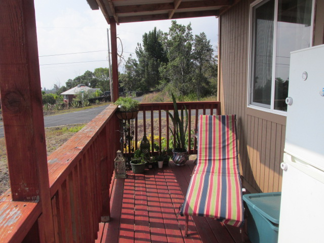 92-8629 Koa Lane Ocean View, HI 96704 - Photo 8 of 12 a balcony with wooden floor