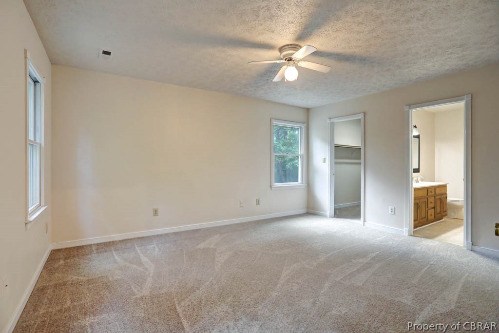 7025 Mumford Cove Road Hayes, VA 23072 - Photo 28 of 43 Master bedroom with walk in closet and full bath