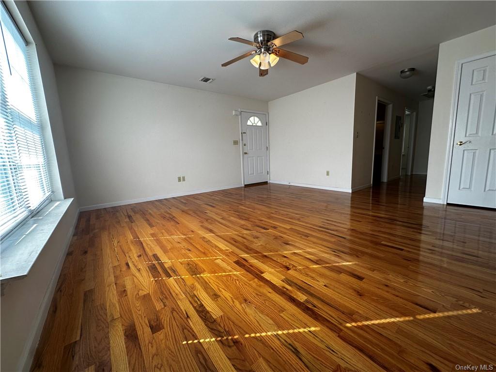 105 South Montgomery Street, Unit B1 4 Walden, NY 12586 - Photo 18 of 20 Unfurnished living room featuring ceiling fan and wood-type flooring
