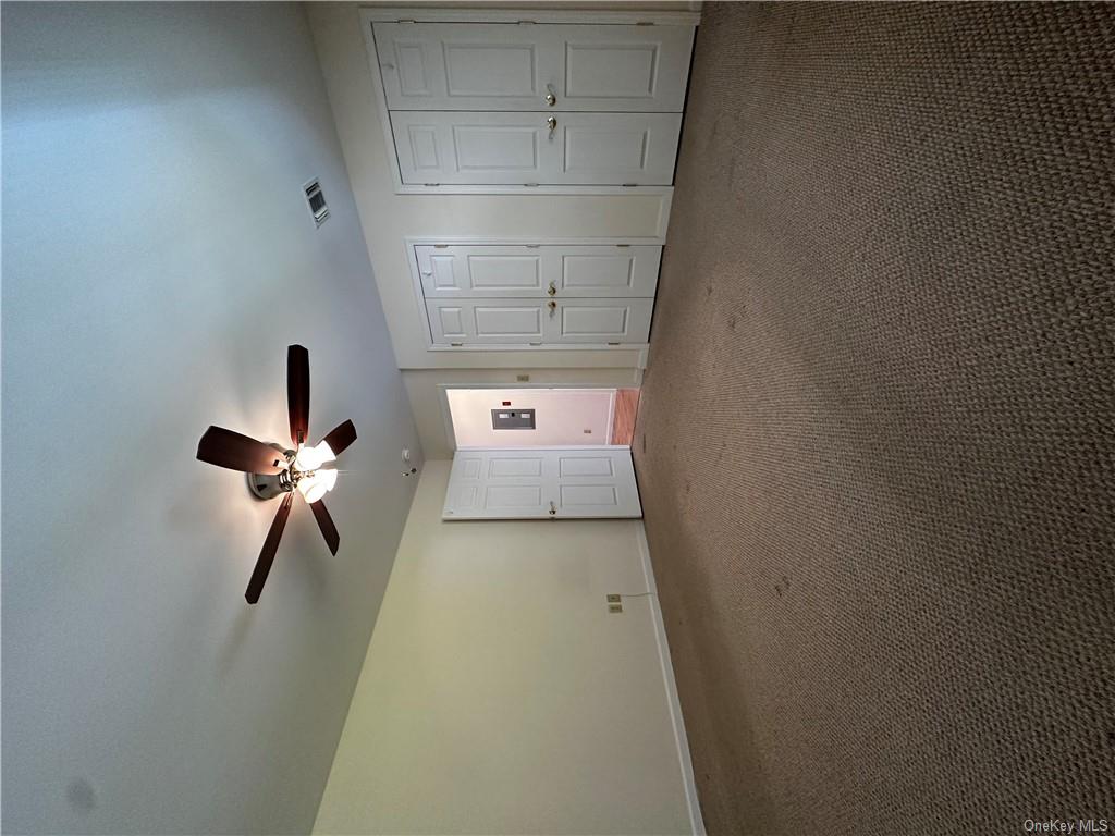 105 South Montgomery Street, Unit B1 4 Walden, NY 12586 - Photo 10 of 20 Unfurnished bedroom featuring ceiling fan, dark colored carpet, and two closets