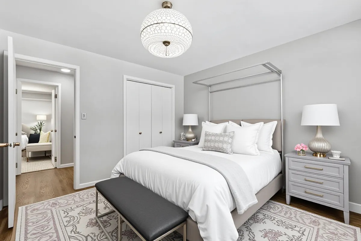 7801 Niles Center Road, Unit 102 Skokie, IL 60077 - Photo 15 of 20 a bedroom with a bed and wooden floor