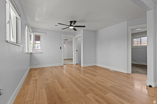 2101 West 3900th Street South Roy, UT 84067 - Photo 7 of 36 Spacious room featuring wood-finish flooring, light gray walls, and a ceiling fan with integrated lighting