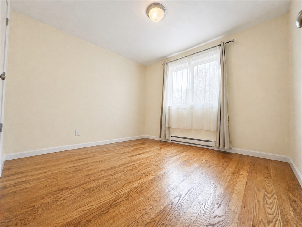 92 Sandwich Road, Unit 4D Bourne, MA 02532 - Photo 11 of 18 a view of an empty room and wooden floor