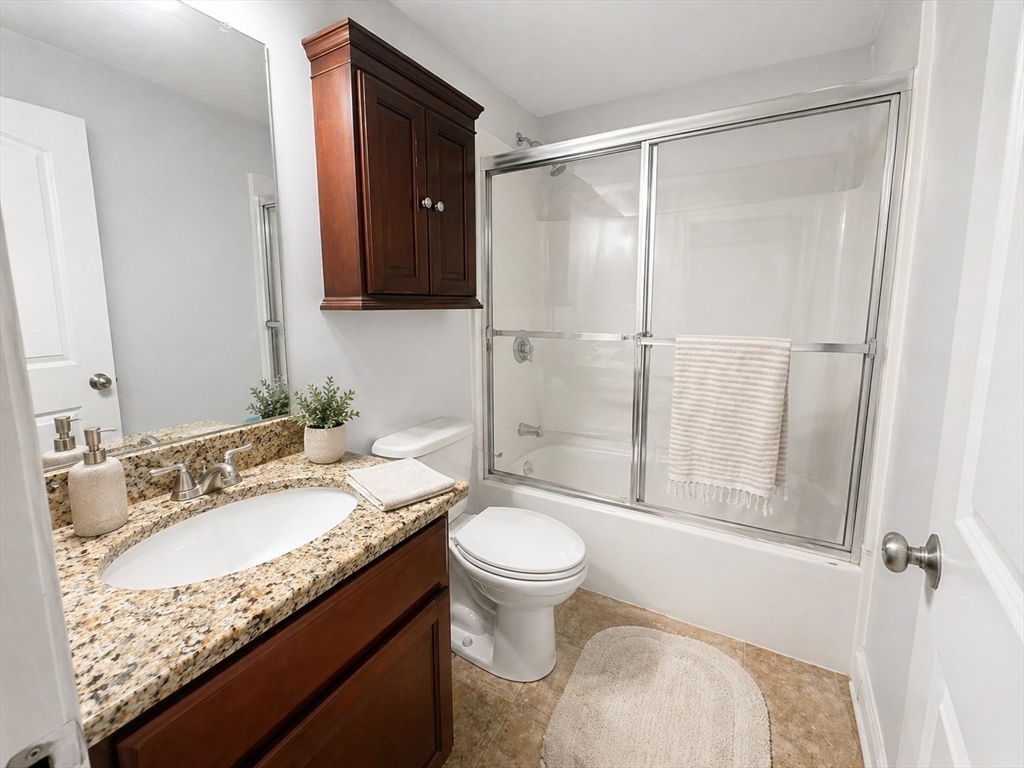 92 Sandwich Road, Unit 4D Bourne, MA 02532 - Photo 12 of 18 a bathroom with a granite countertop sink toilet and shower