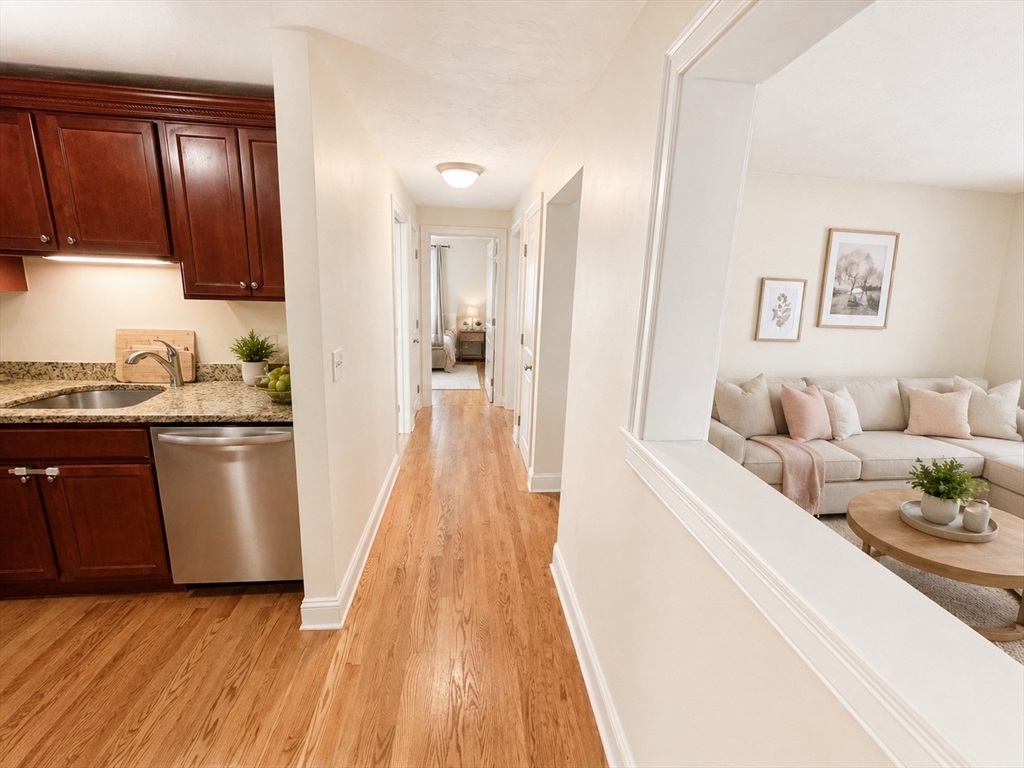 92 Sandwich Road, Unit 4D Bourne, MA 02532 - Photo 14 of 18 a living room with stainless steel appliances furniture a refrigerator and a wooden floor
