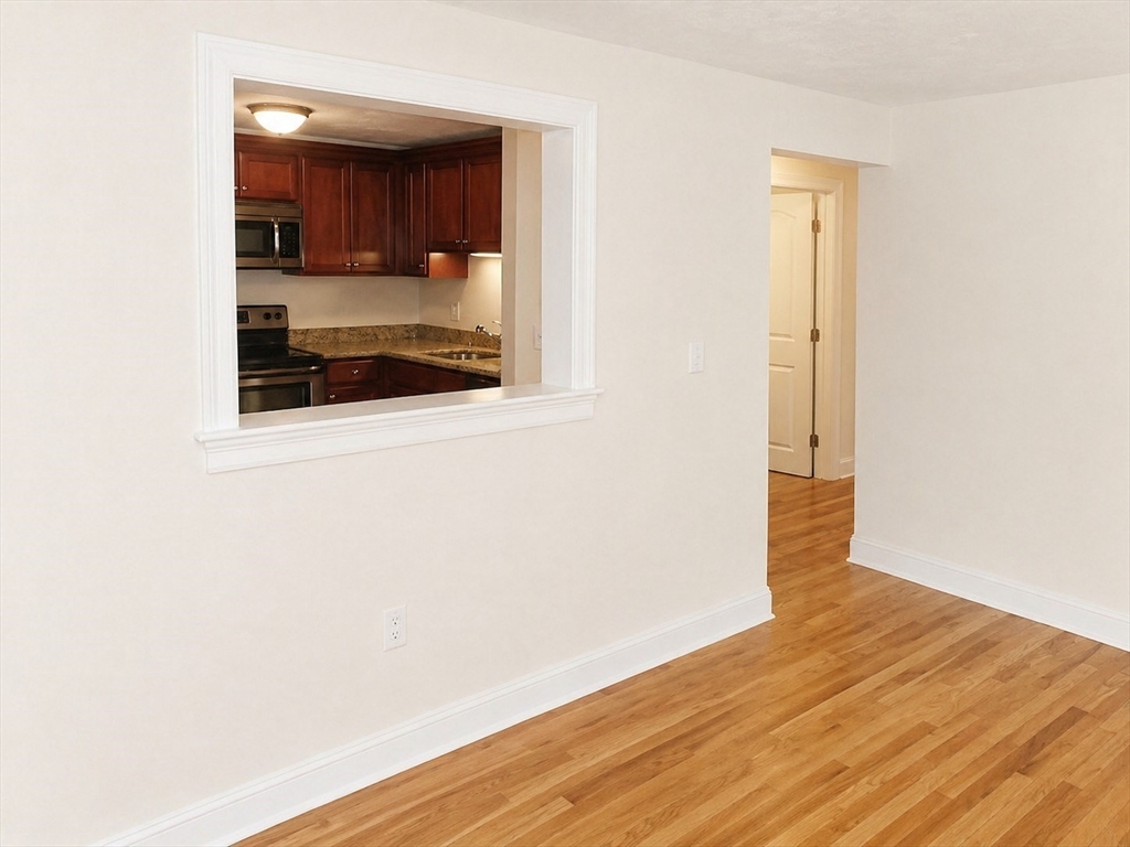 92 Sandwich Road, Unit 4D Bourne, MA 02532 - Photo 16 of 18 a view of a room that has a window and wooden floor