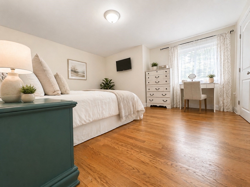 92 Sandwich Road, Unit 4D Bourne, MA 02532 - Photo 7 of 18 a bedroom with a bed and wooden floor