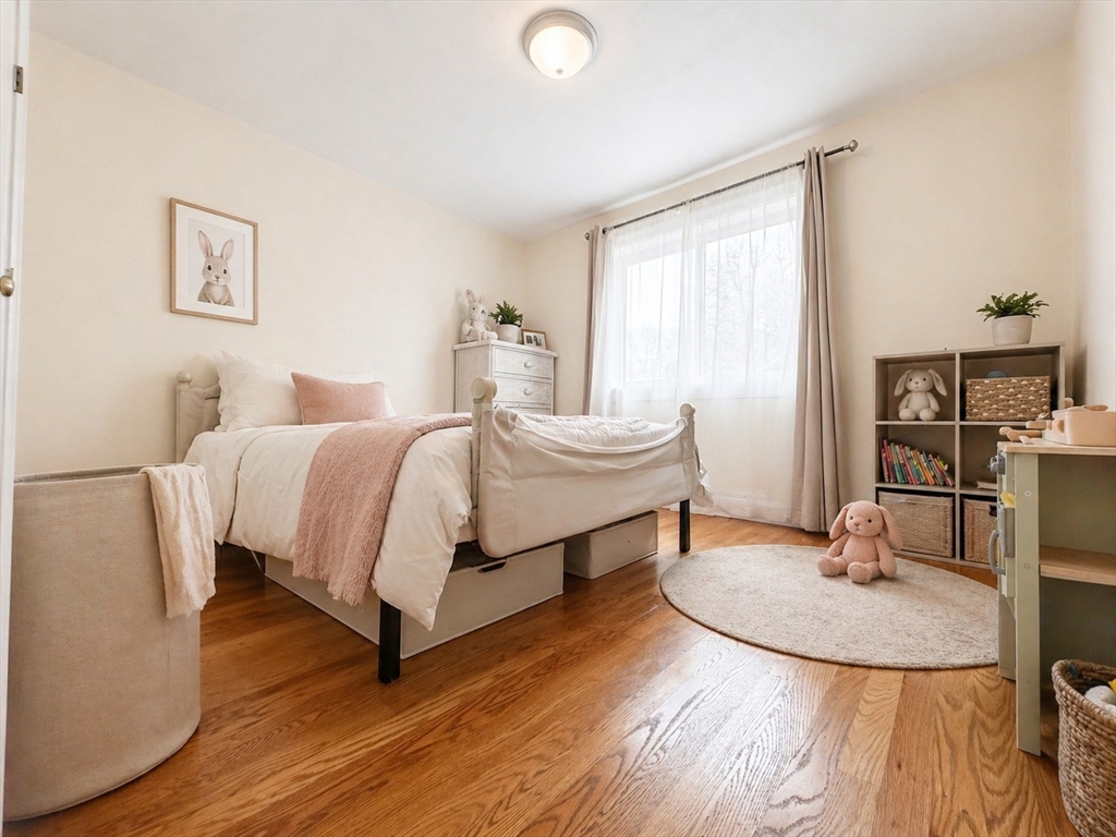 92 Sandwich Road, Unit 4D Bourne, MA 02532 - Photo 10 of 18 a bedroom with a bed a table and chair