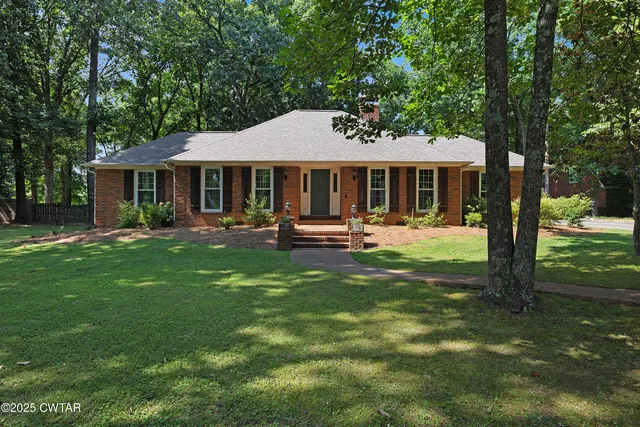 a view of a house with a backyard porch and sitting area