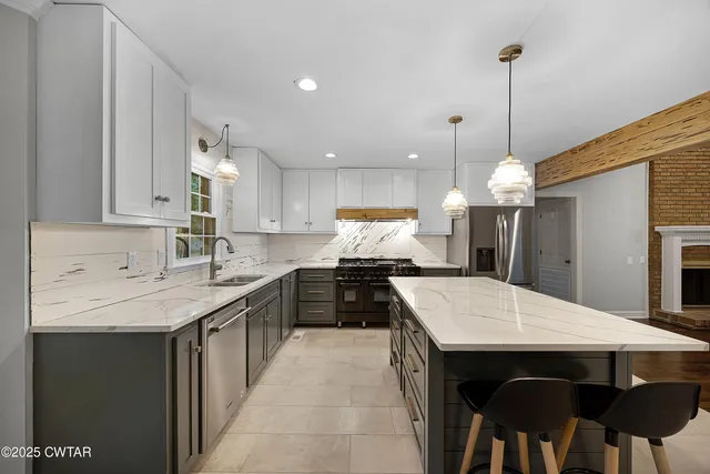 a kitchen with a stove a sink a dining table and chairs