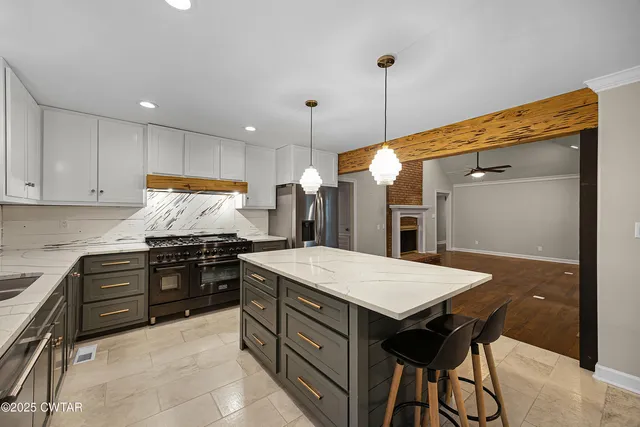 a kitchen with a stove a refrigerator and a sink