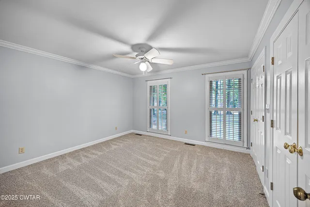 a view of an empty room with windows