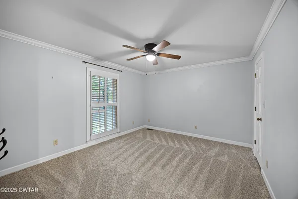 a view of empty room with ceiling fan
