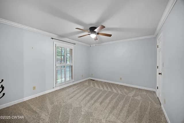 a view of empty room with ceiling fan