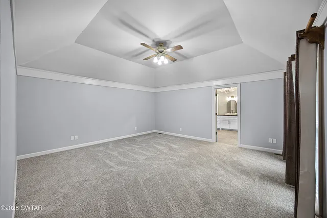 a view of an empty room and a ceiling fan