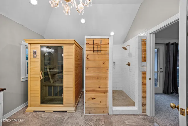 a view of a hallway with wooden floor and dining room