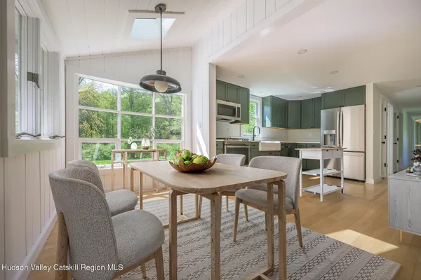 a dining room with furniture a chandelier and wooden floor