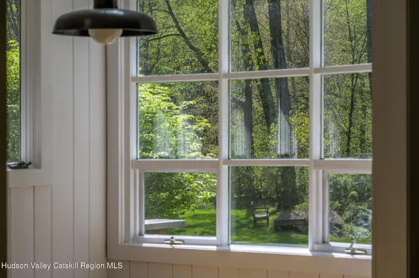 a view of a room with a large window and front door