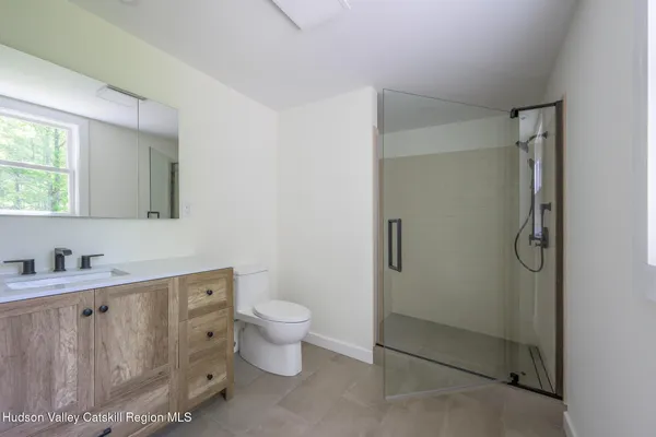 a bathroom with a sink toilet and shower