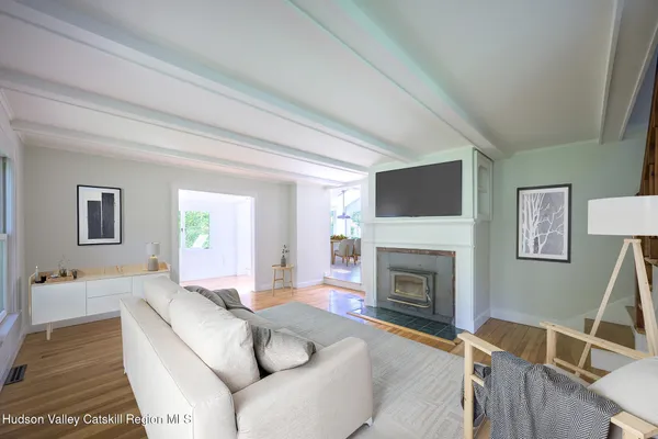 a living room with furniture a fireplace and a flat screen tv