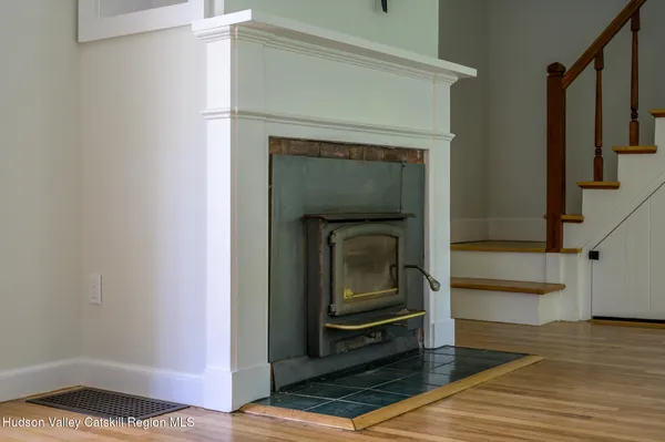 a living room with a fireplace and a rug