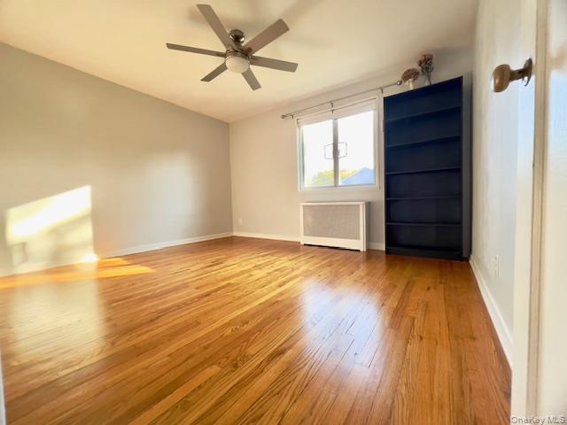 216-37 68th Avenue, Unit 2 Queens, NY 11364 - Photo 11 of 27 wooden floor in an empty room with a window