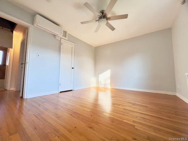 216-37 68th Avenue, Unit 2 Queens, NY 11364 - Photo 12 of 27 a view of an empty room with wooden floor and a ceiling fan