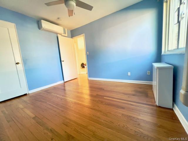 216-37 68th Avenue, Unit 2 Queens, NY 11364 - Photo 13 of 27 an empty room with wooden floor and windows