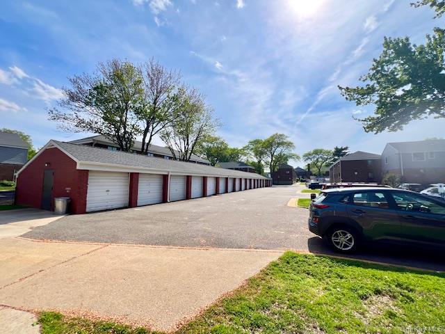 216-37 68th Avenue, Unit 2 Queens, NY 11364 - Photo 20 of 27 a car parked in front of white house