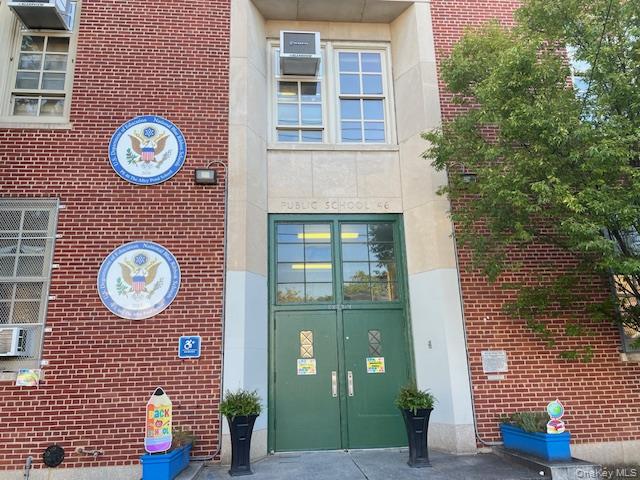 216-37 68th Avenue, Unit 2 Queens, NY 11364 - Photo 24 of 27 a front view of a brick building with a clock on the wall