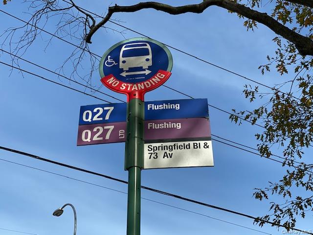 216-37 68th Avenue, Unit 2 Queens, NY 11364 - Photo 25 of 27 a sign on a wall next to a road