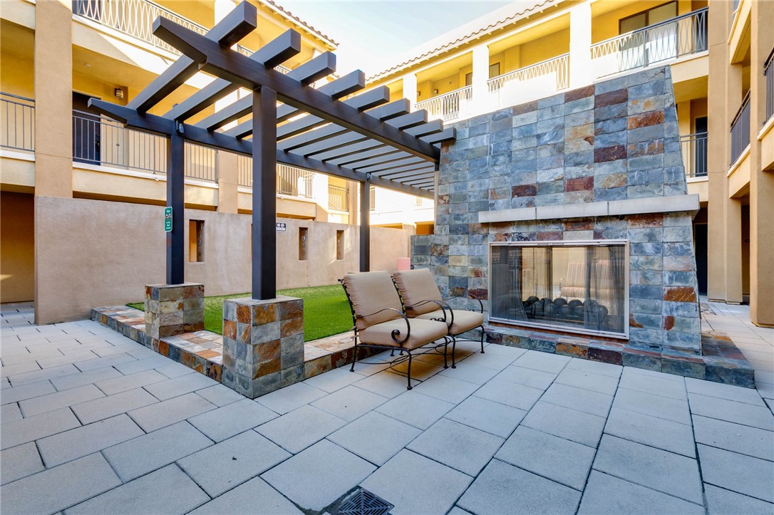 408 West Main Street, Unit 2G Alhambra, CA 91801 - Photo 22 of 30 a backyard of a house with barbeque oven table and chairs