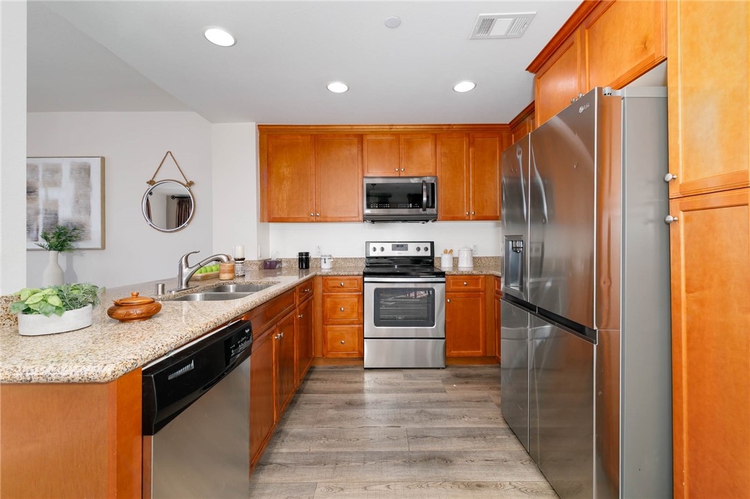 408 West Main Street, Unit 2G Alhambra, CA 91801 - Photo 7 of 30 a kitchen with stainless steel appliances granite countertop a sink and a refrigerator