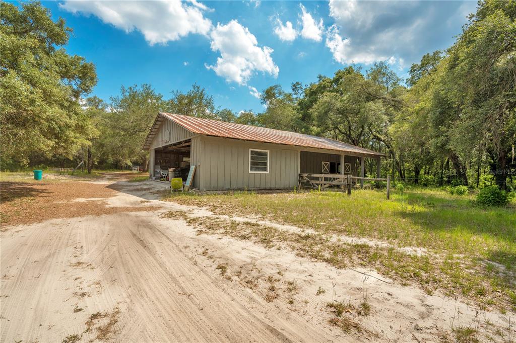 1 EAST Rd Spring Hill Hudson, FL 34667 - Photo 32 of 41 a front view of a house with a garden