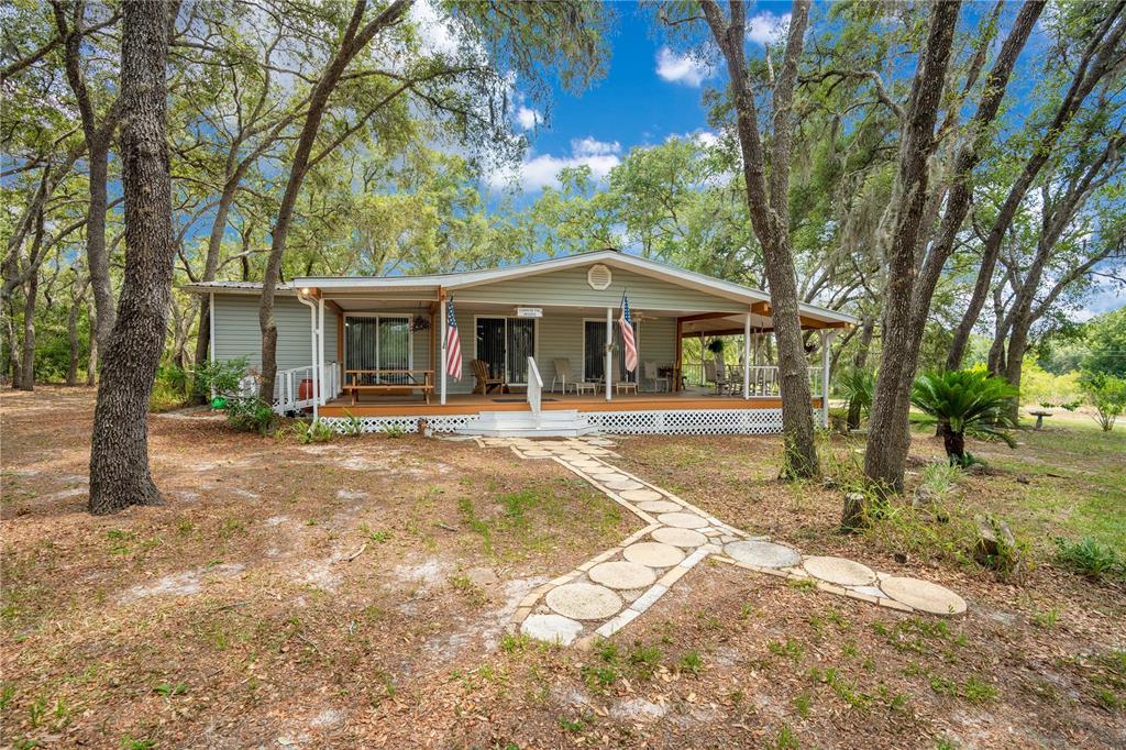 1 EAST Rd Spring Hill Hudson, FL 34667 - Photo 37 of 41 a front view of a house with garden