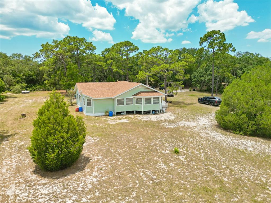 1 EAST Rd Spring Hill Hudson, FL 34667 - Photo 40 of 41 a view of a house with a yard and potted plants