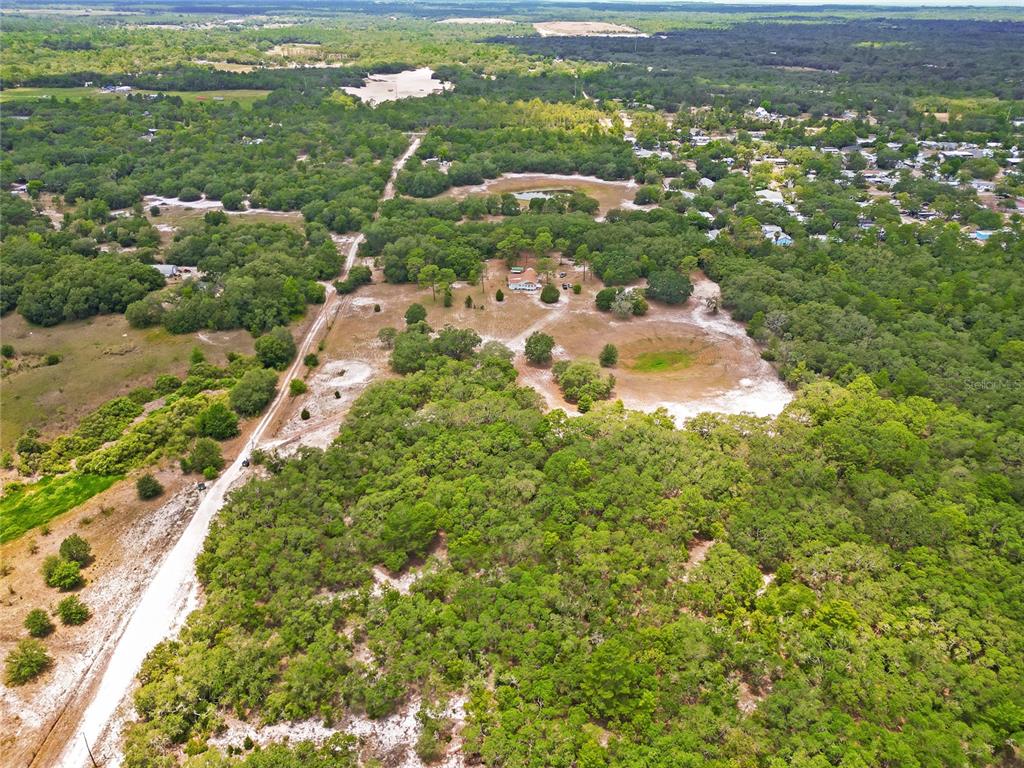1 EAST Rd Spring Hill Hudson, FL 34667 - Photo 4 of 41 an aerial view of residential houses with outdoor space and trees