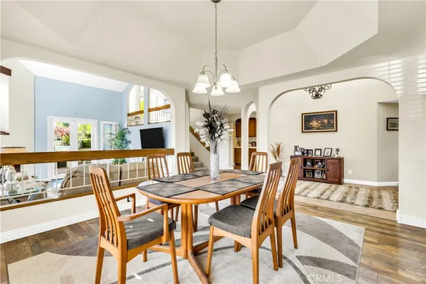 a view of a dining room with furniture and a chandelier
