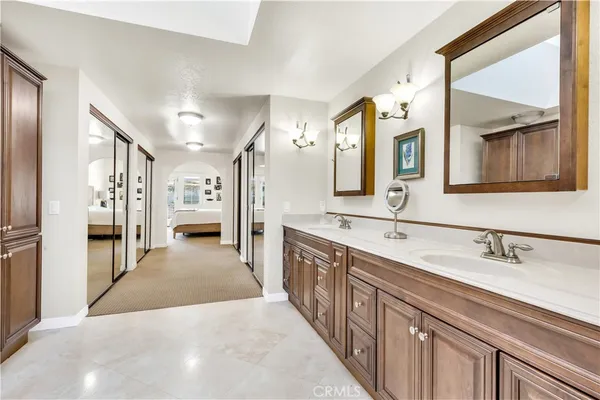 a large white kitchen with lots of counter space and glass door