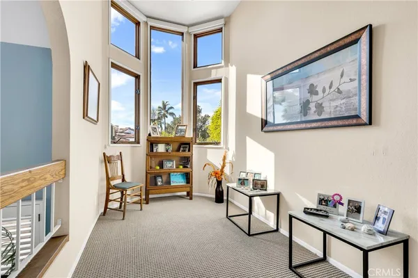 a spacious bedroom with a bed chair and a large window