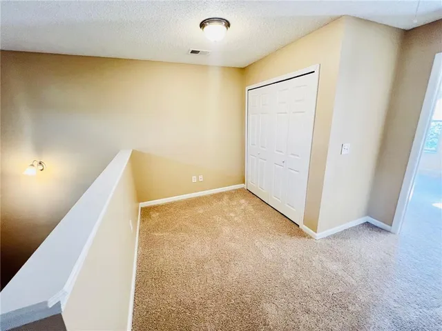 a view of an empty room with windows