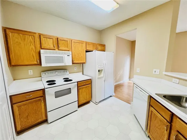 a kitchen with a stove a sink and a refrigerator