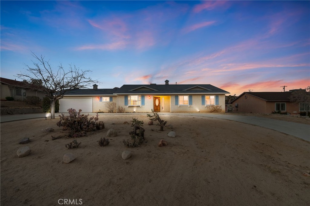 57622 Sierra Way Yucca Valley, CA 92284 - Photo 1 of 75 a front view of a house with a yard