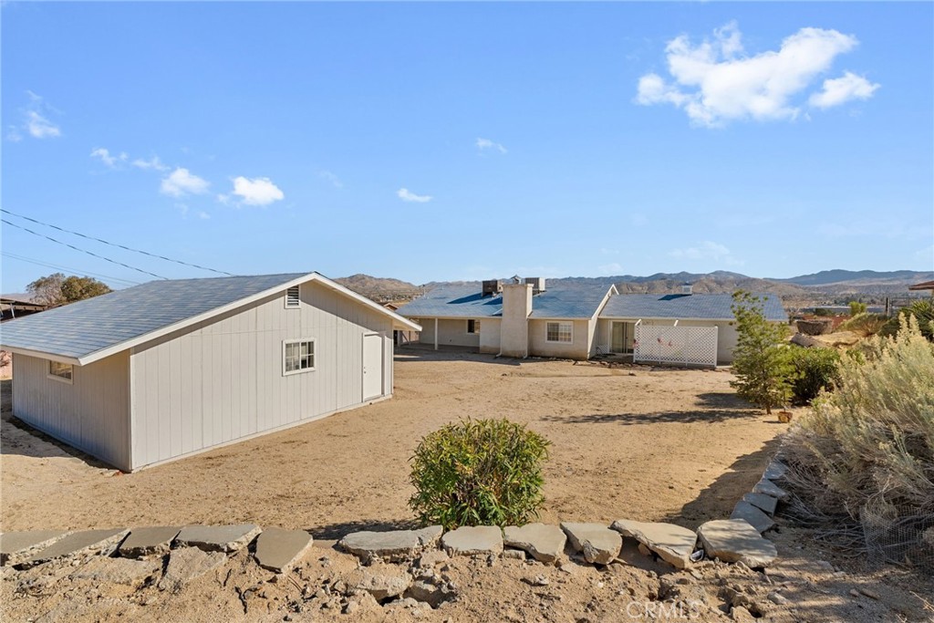 57622 Sierra Way Yucca Valley, CA 92284 - Photo 11 of 75 a view of a house with a snow in the background