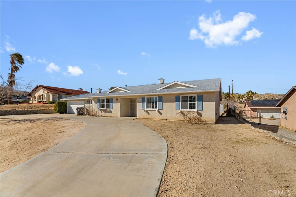57622 Sierra Way Yucca Valley, CA 92284 - Photo 2 of 75 a front view of a house with a yard