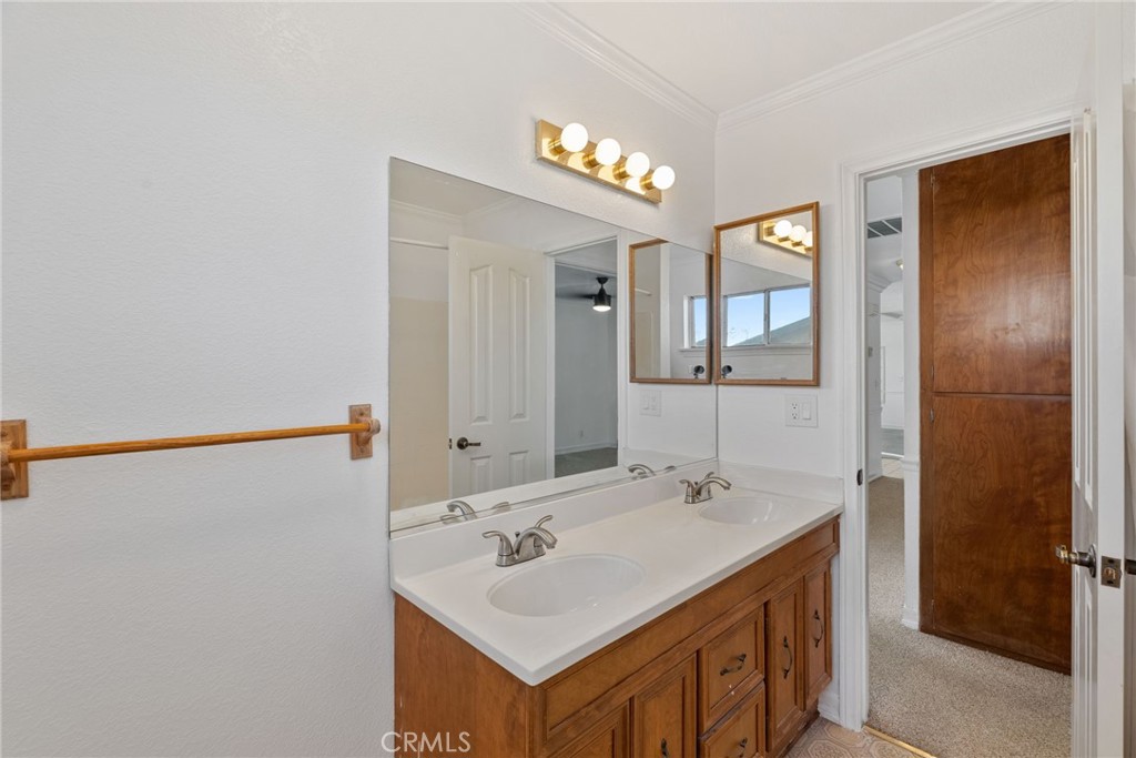 57622 Sierra Way Yucca Valley, CA 92284 - Photo 31 of 75 a bathroom with a sink a light fixture and a mirror