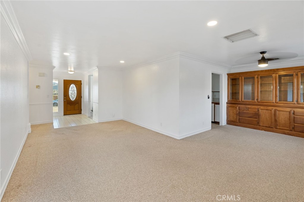 57622 Sierra Way Yucca Valley, CA 92284 - Photo 45 of 75 an empty room with chandelier fan and windows
