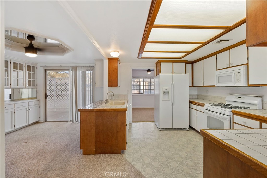 57622 Sierra Way Yucca Valley, CA 92284 - Photo 49 of 75 a kitchen with stainless steel appliances granite countertop a refrigerator a stove and a sink with couches